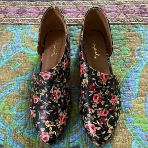 Black shoe with pink flowers and green leaves